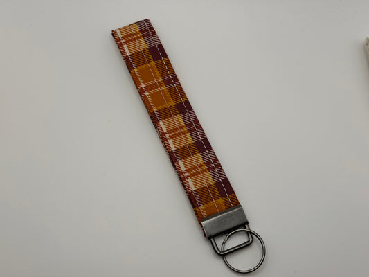 Fall plaid key fob wristlet in burgundy, orange, and gold with silver clasp