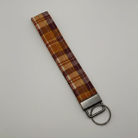 Professional product photo of fall plaid key fob wristlet