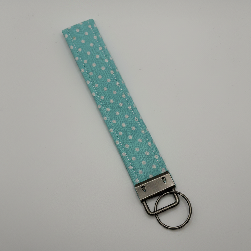 Professional product photo of light blue polka dot key fob wristlet